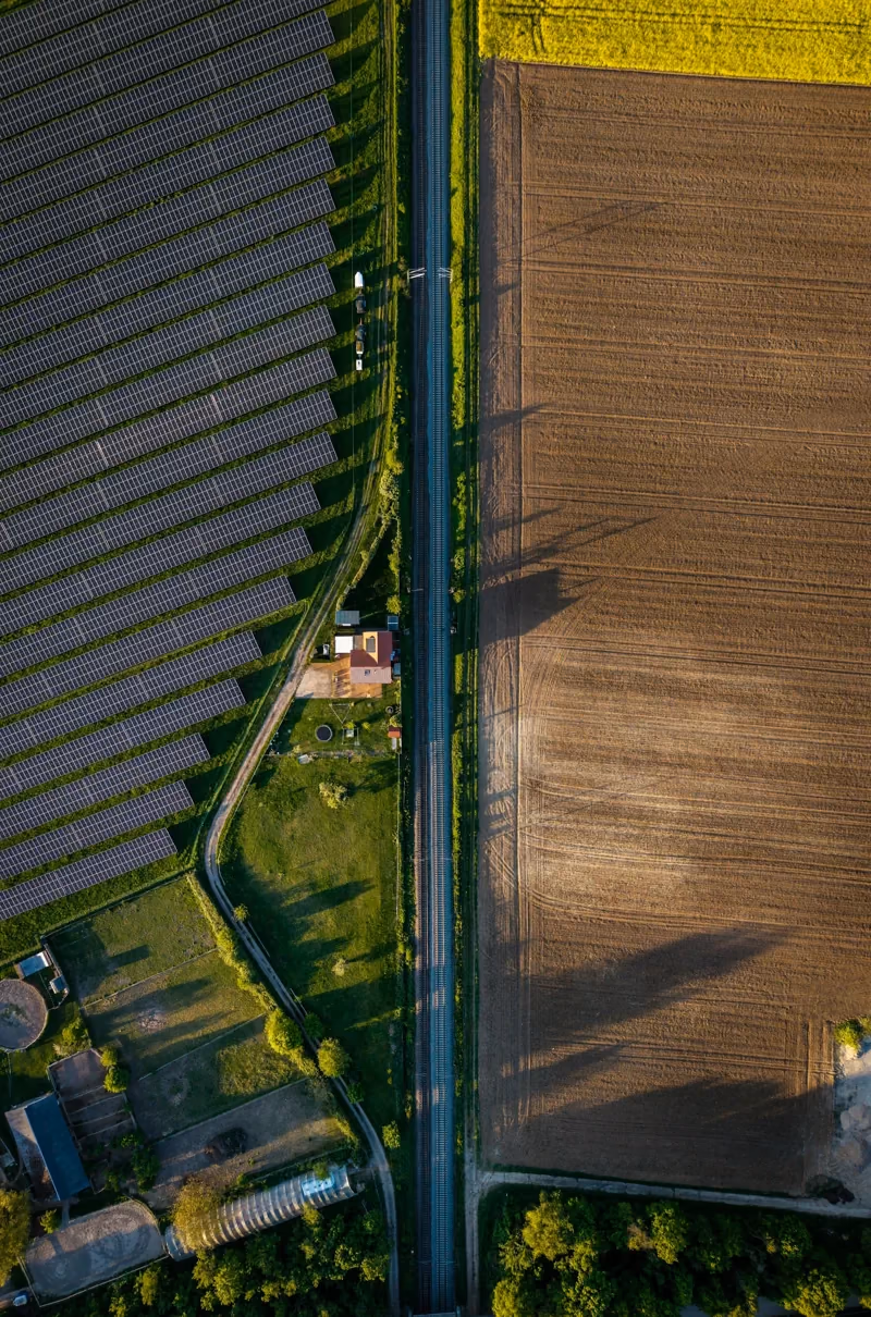 Representative aerial view of farmland beside a solar array